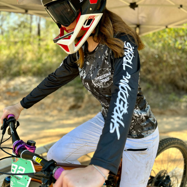 Womens black camo long sleeve Jersey. Made by Shredding Trails. Contours seamlessly around body armour like a glove. Proudly manufactured in Australia from recycled plastic bottles.