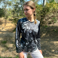 Load image into Gallery viewer, Womens black camo long sleeve Jersey. Made by Shredding Trails. Contours seamlessly around body armour like a glove. Proudly manufactured in Australia from recycled plastic bottles.
