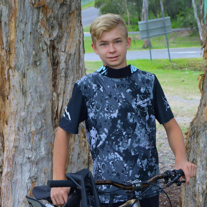 Kai Pyyvaara wearing our short sleeve black camo jersey . Available in youth sizes and made in Australia from recycled plastic.